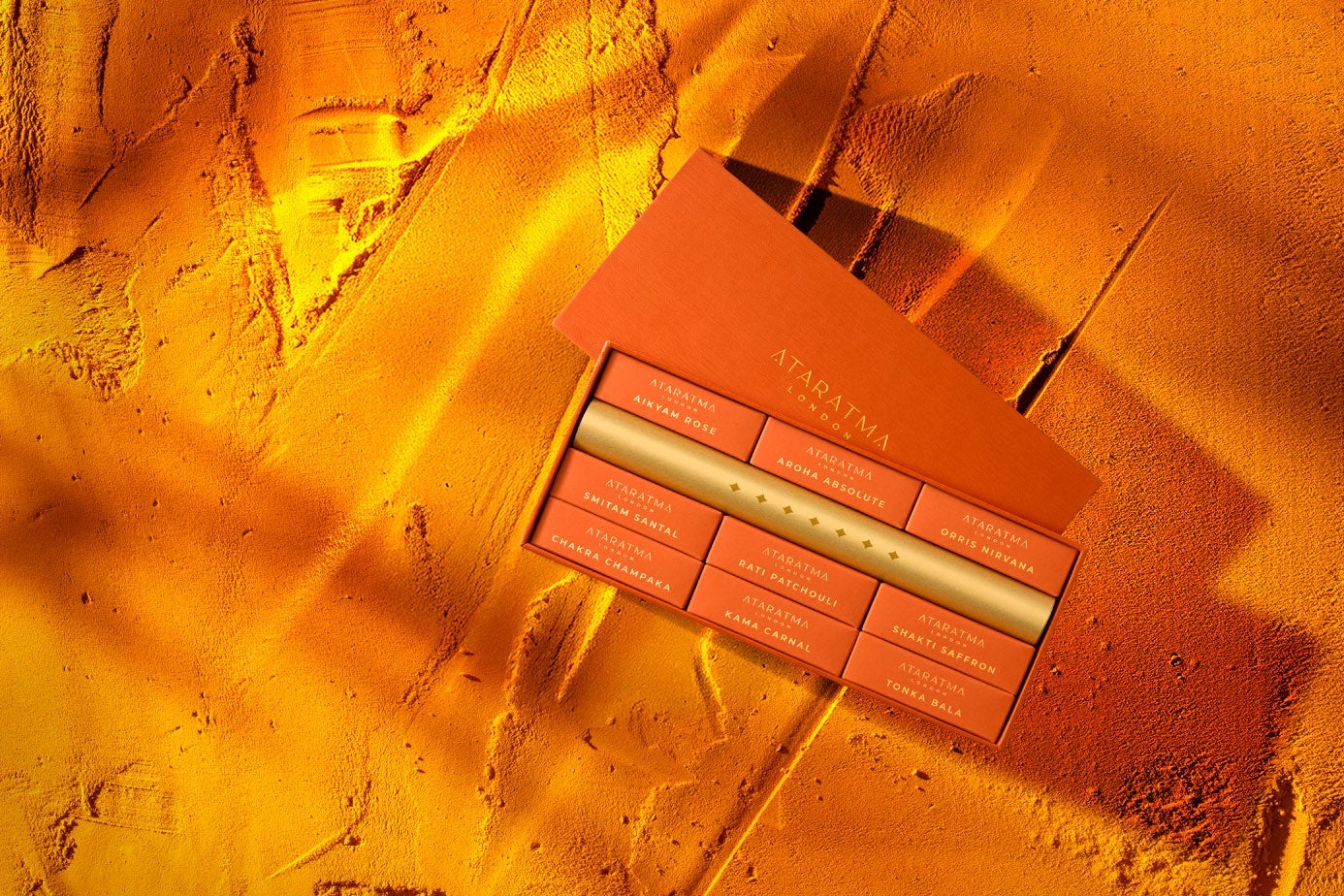 Gift Discovery perfume sample set on sandy background